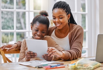 Child and mother enjoy educational content on an iPad