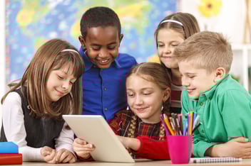 Students in classroom enjoying Pubbly on a tablet.